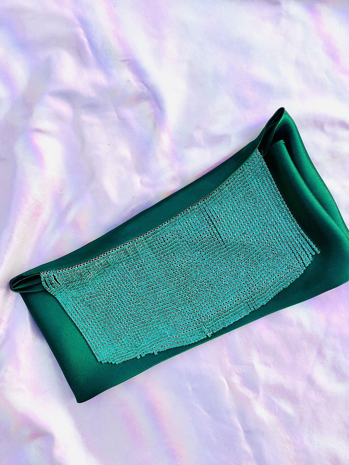 Freya handmade green satin bandana bang with turquoise fringe laid flat on iridescent background