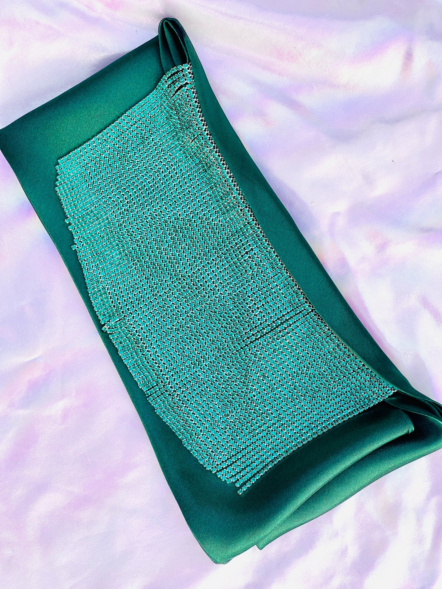 Freya handmade green satin bandana bang with turquoise fringe laid flat on iridescent background