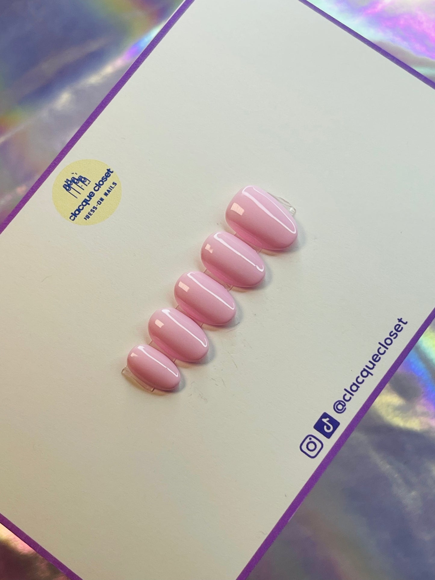 A set of press-on nails in a delicate baby pink shade, offering a soft and feminine appearance with a smooth, glossy finish.