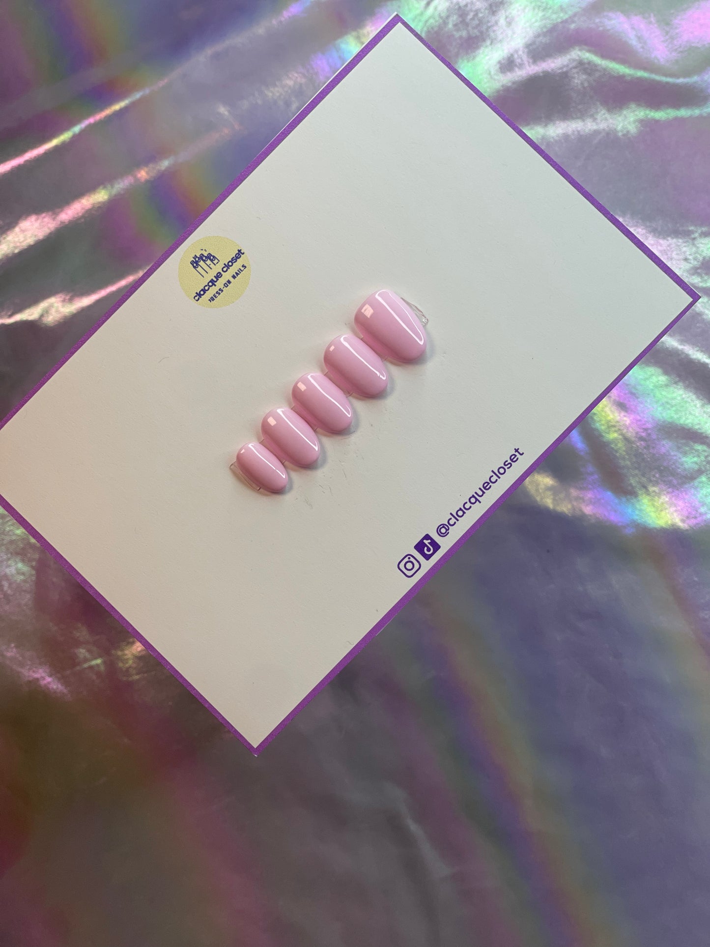 A set of press-on nails in a delicate baby pink shade, offering a soft and feminine appearance with a smooth, glossy finish.