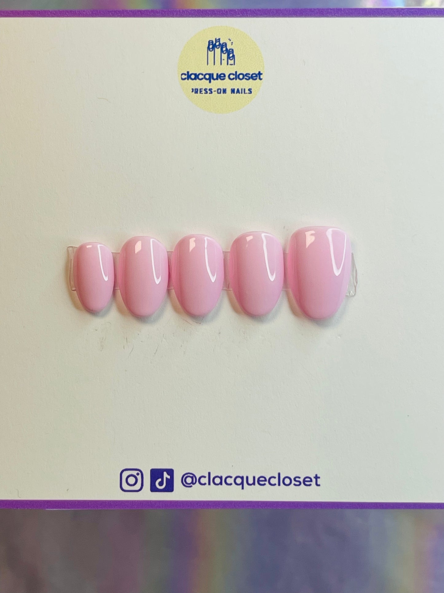 A set of press-on nails in a delicate baby pink shade, offering a soft and feminine appearance with a smooth, glossy finish.