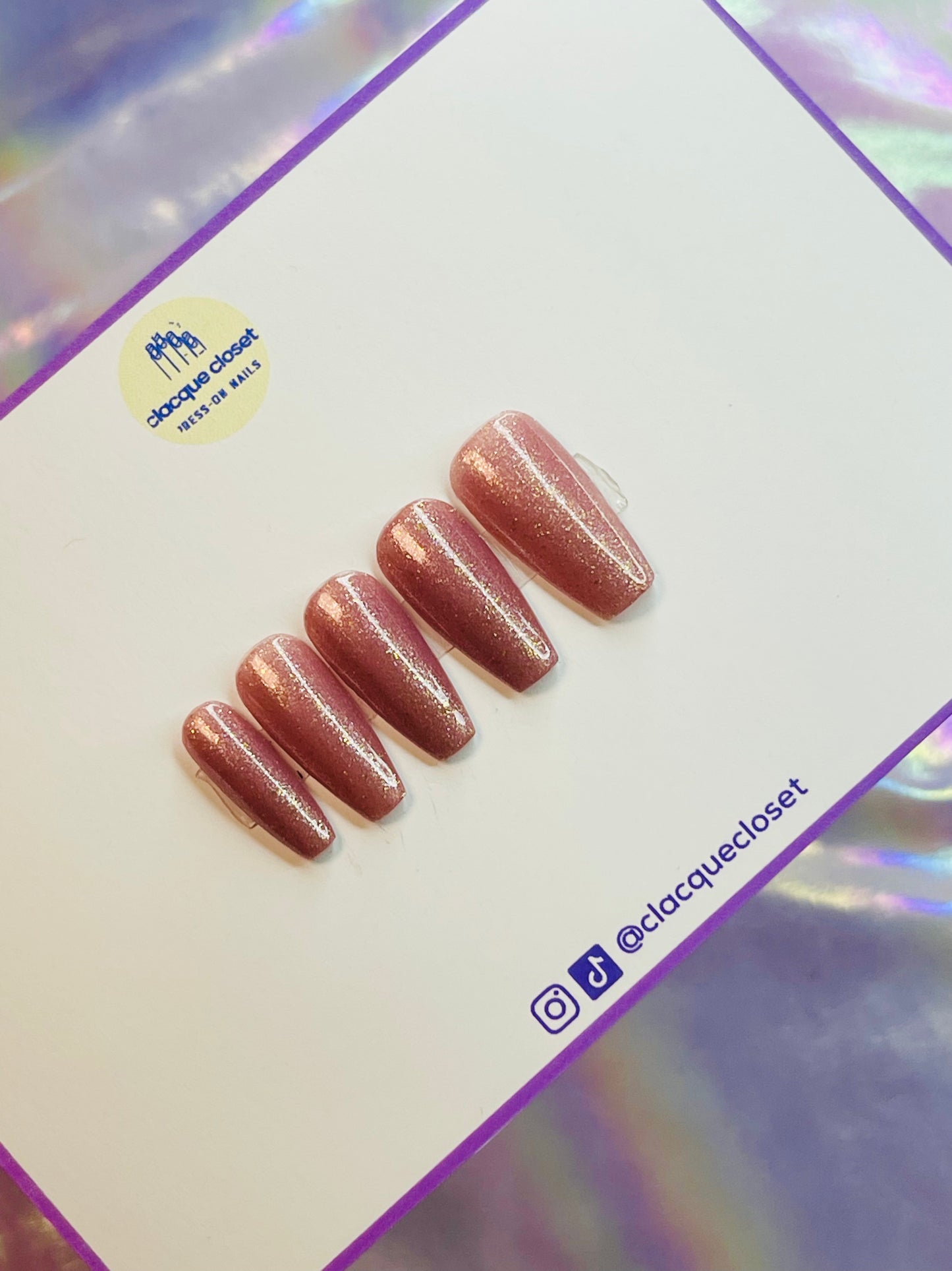 A set of coffin-shaped nails in a sparkling nude tone, offering a subtle yet glamorous look with a refined, elegant finish.