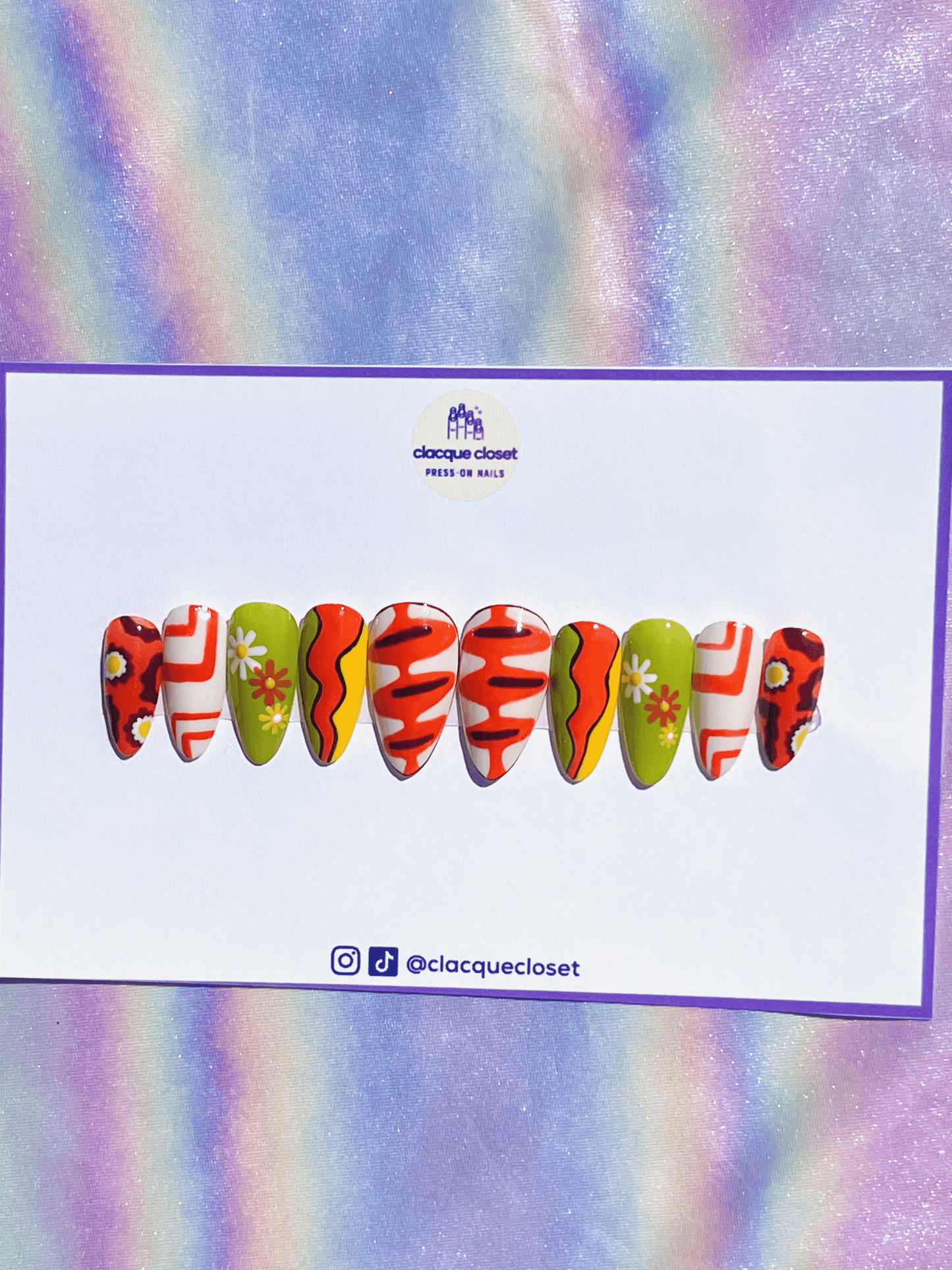 70s-inspired press-on nails featuring vibrant orange, green, and yellow colors for a retro and bold look.