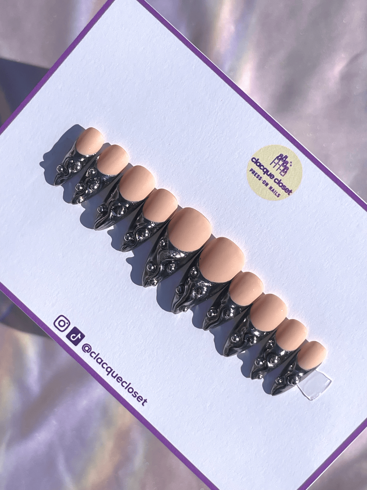 French tip press-on nails with a silver chrome finish, embellished with silver balls for a chic and glamorous look.