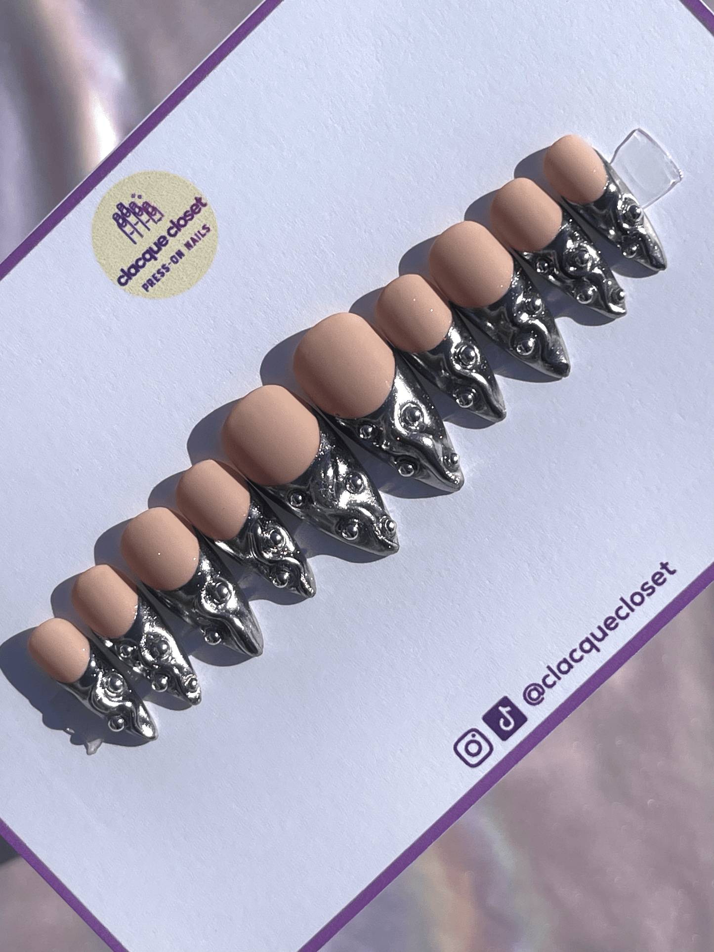 French tip press-on nails with a silver chrome finish, embellished with silver balls for a chic and glamorous look.
