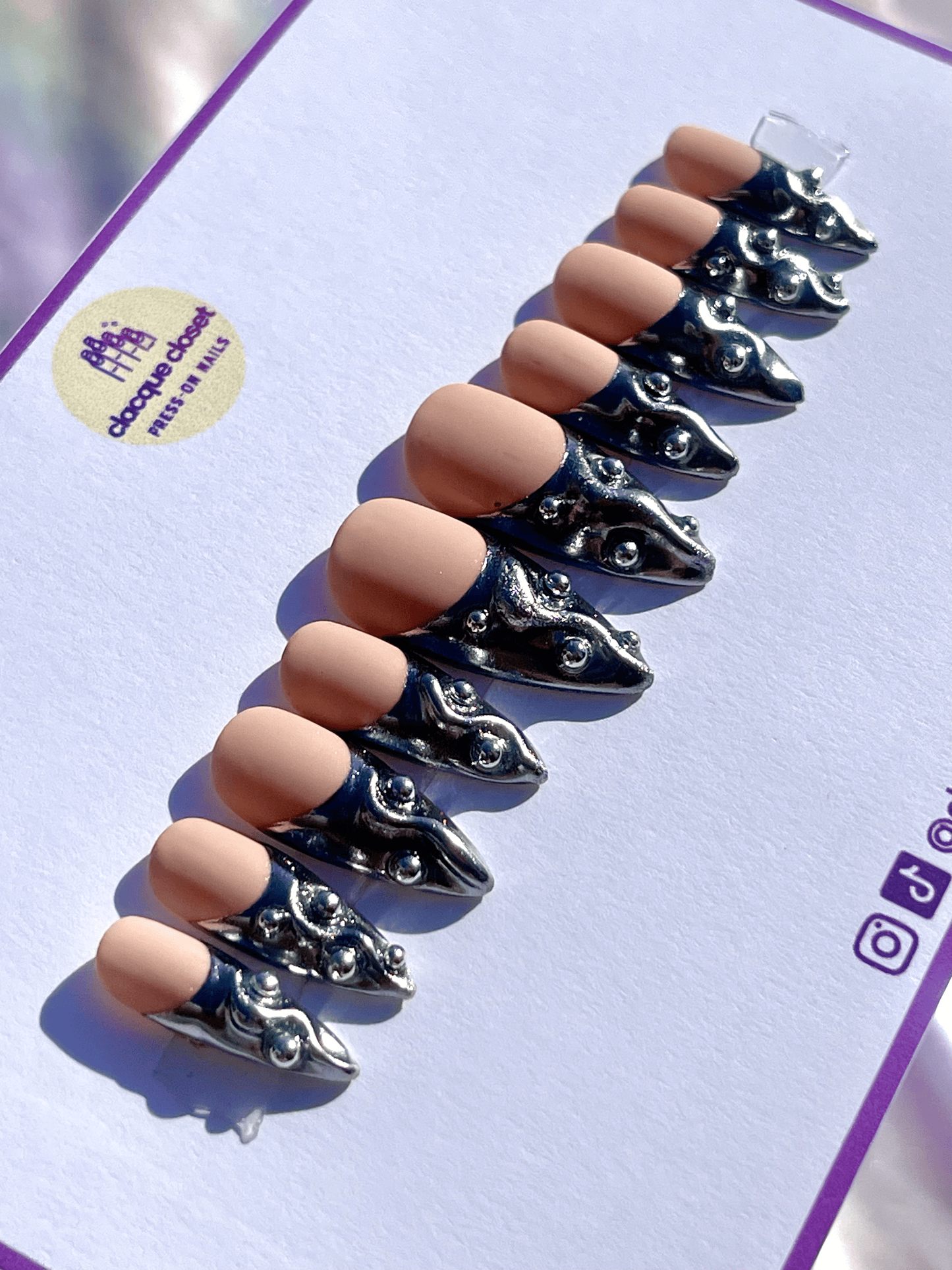 French tip press-on nails with a silver chrome finish, embellished with silver balls for a chic and glamorous look.