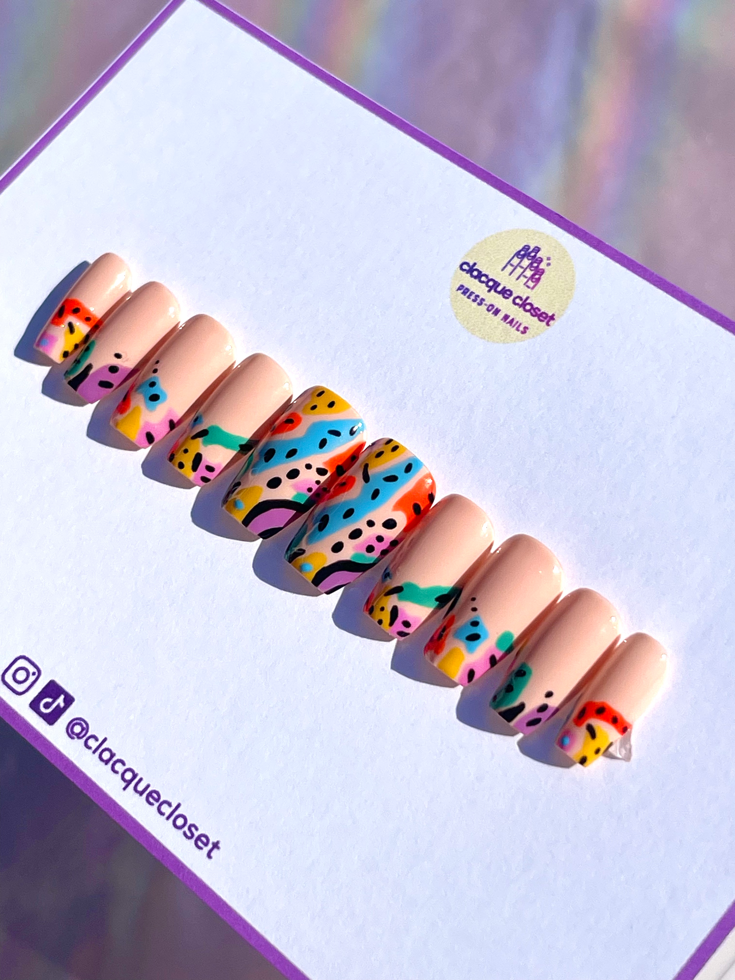 Coffin-shaped press-on nails featuring multi-colored line art for a vibrant and artistic design.