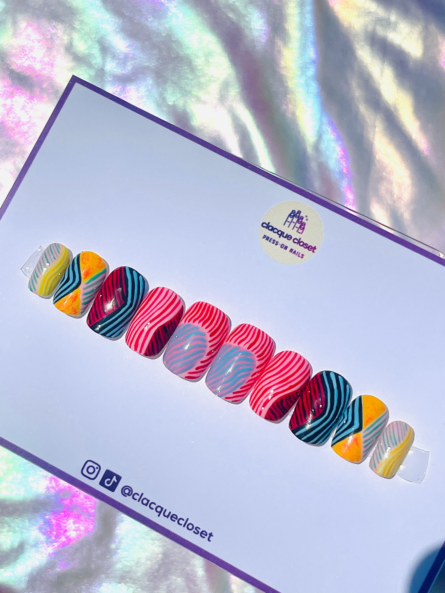 Medium square-shaped press-on nails decorated with vibrant, colorful line art for a playful and artistic appearance.