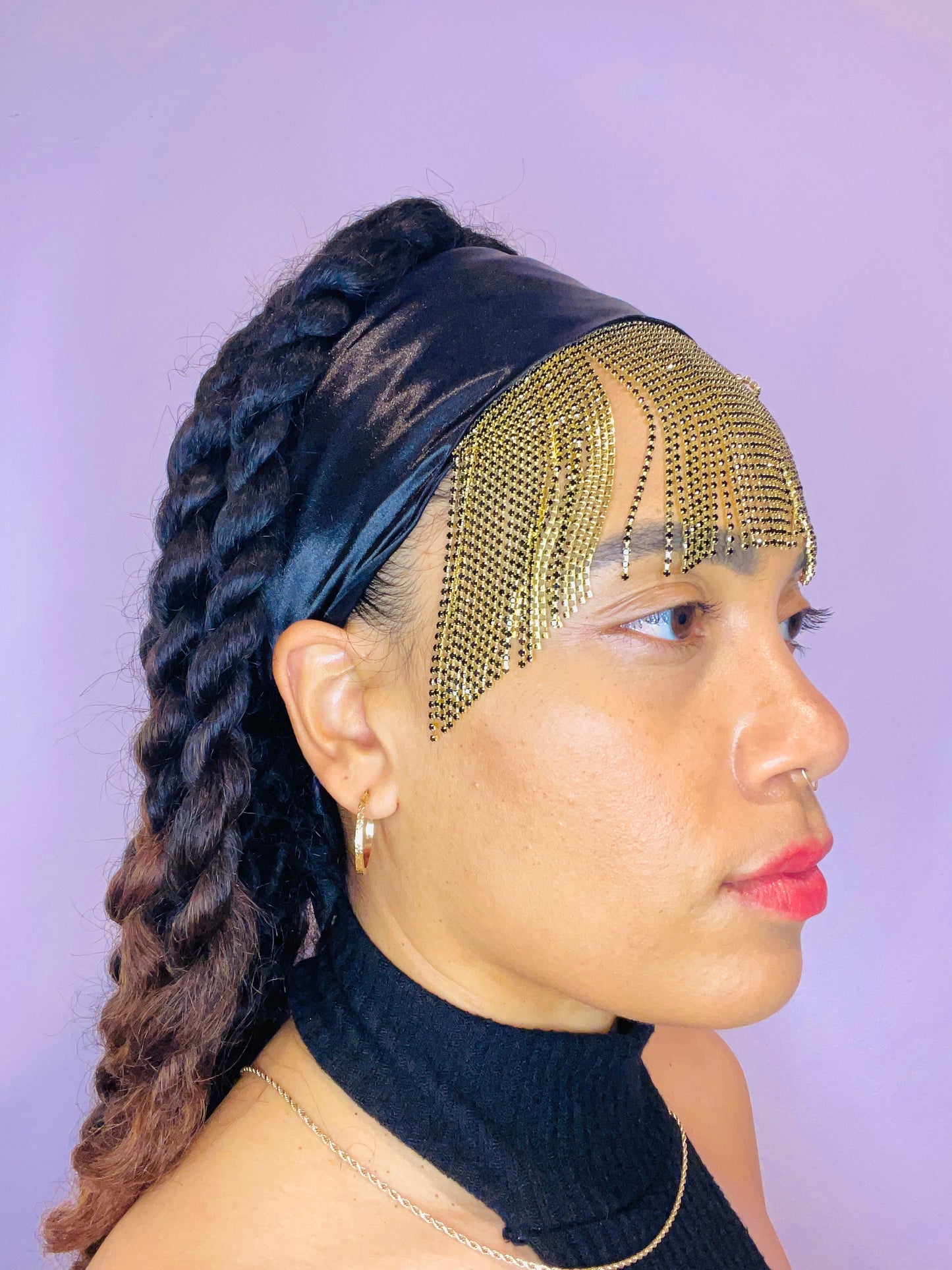 Model wearing the Minerva black and gold bandana bang with front fringe and tied in the back