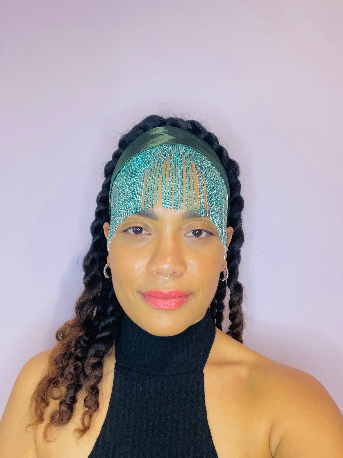 Model wearing the Freya emerald green bandana bang tied in the back with turquoise fringe detail.