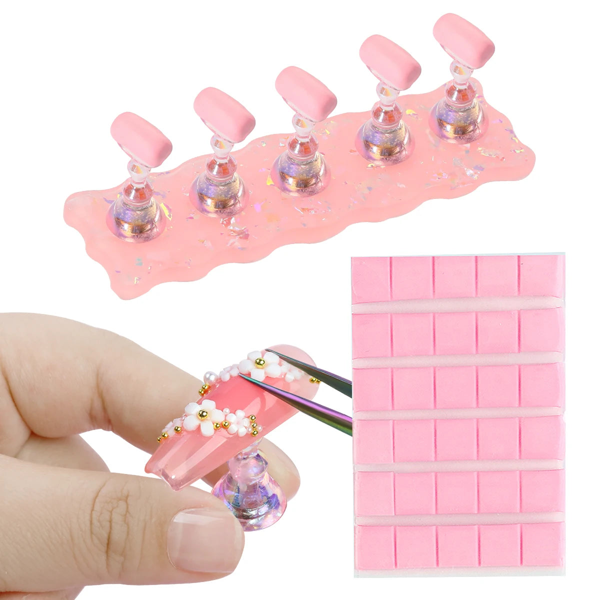 Pink nail art display stand with nail tips and a hand using scissors, on a white background.