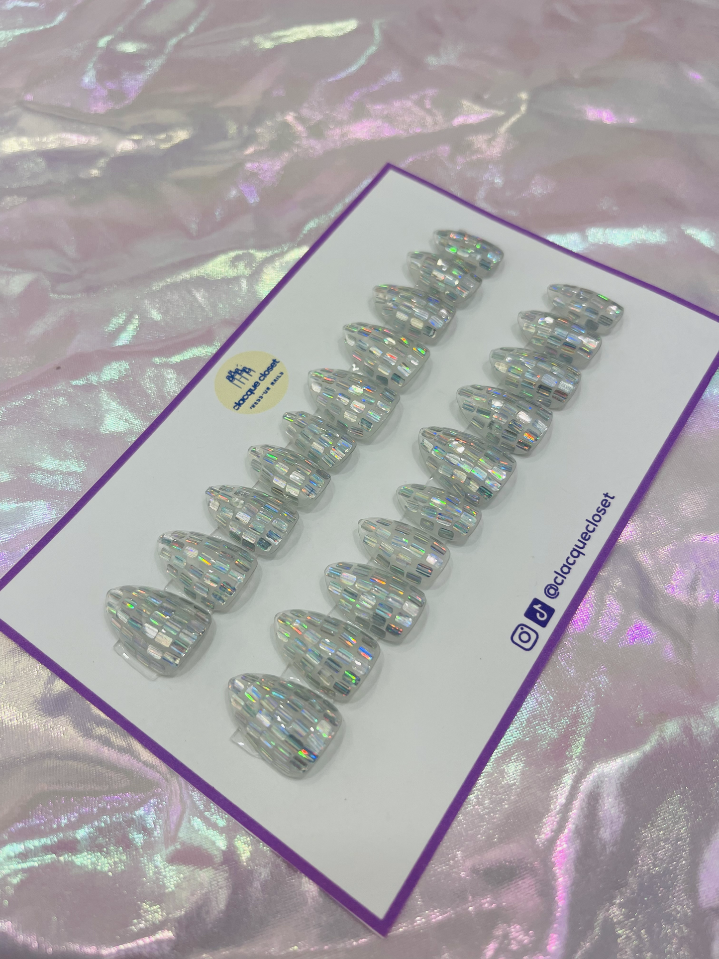 Medium almond-shaped press-on nails with a small size, adorned with square silver iridescent glitter for a sparkling finish.