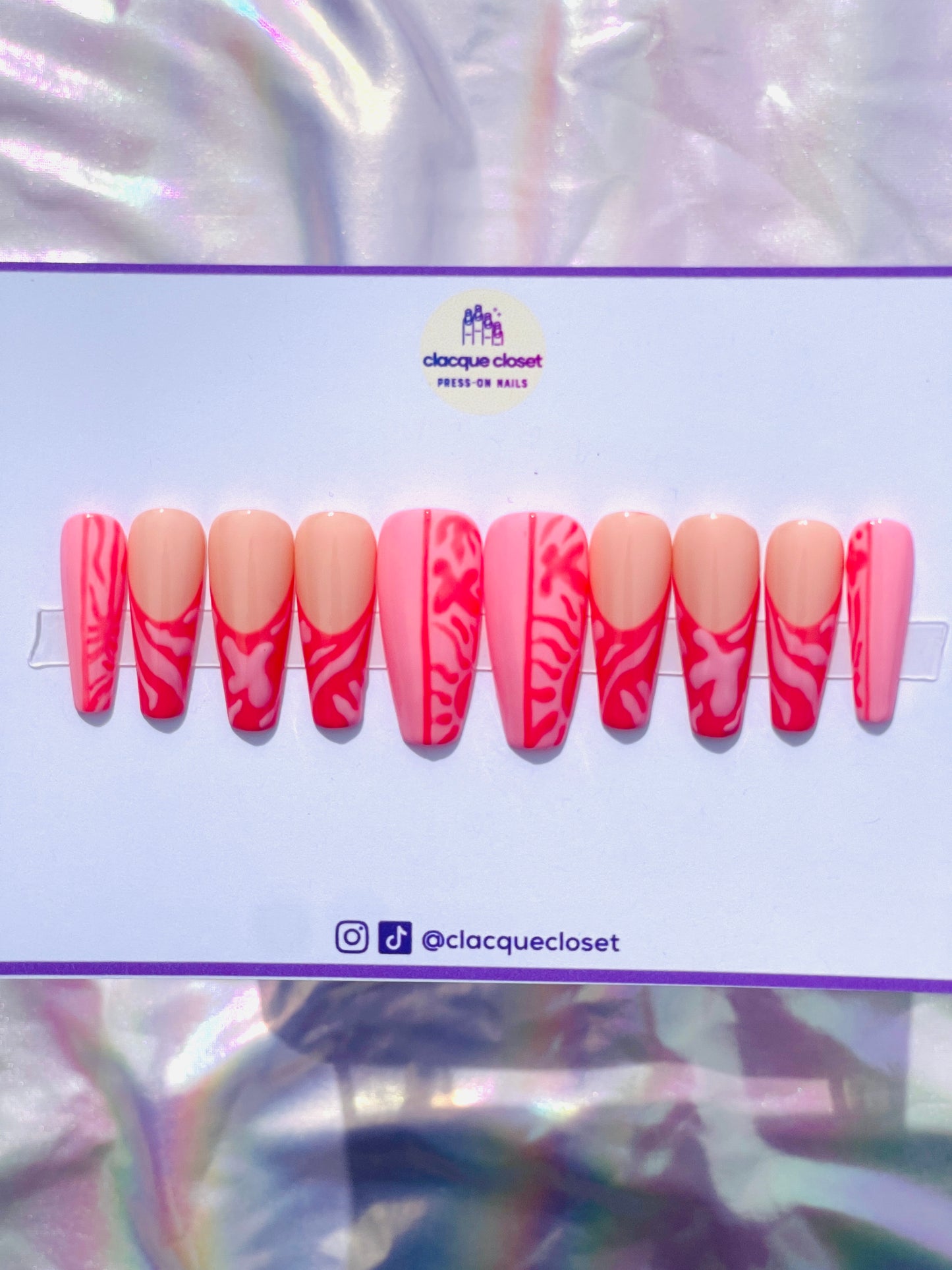 Long coffin-shaped nails featuring a unique blend of pink and red hues, decorated with abstract art designs for a modern and artistic flair.