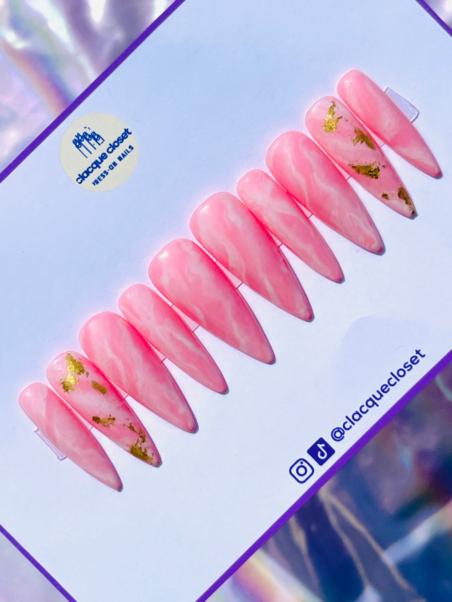 Long stiletto nails designed to resemble the natural beauty of pink rose quartz, reflecting light for a soft and romantic effect.