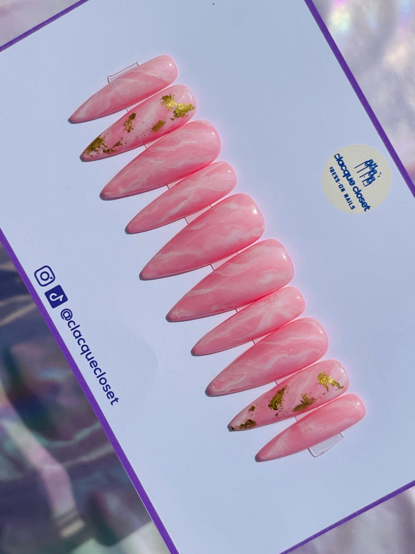 Long stiletto nails designed to resemble the natural beauty of pink rose quartz, reflecting light for a soft and romantic effect.