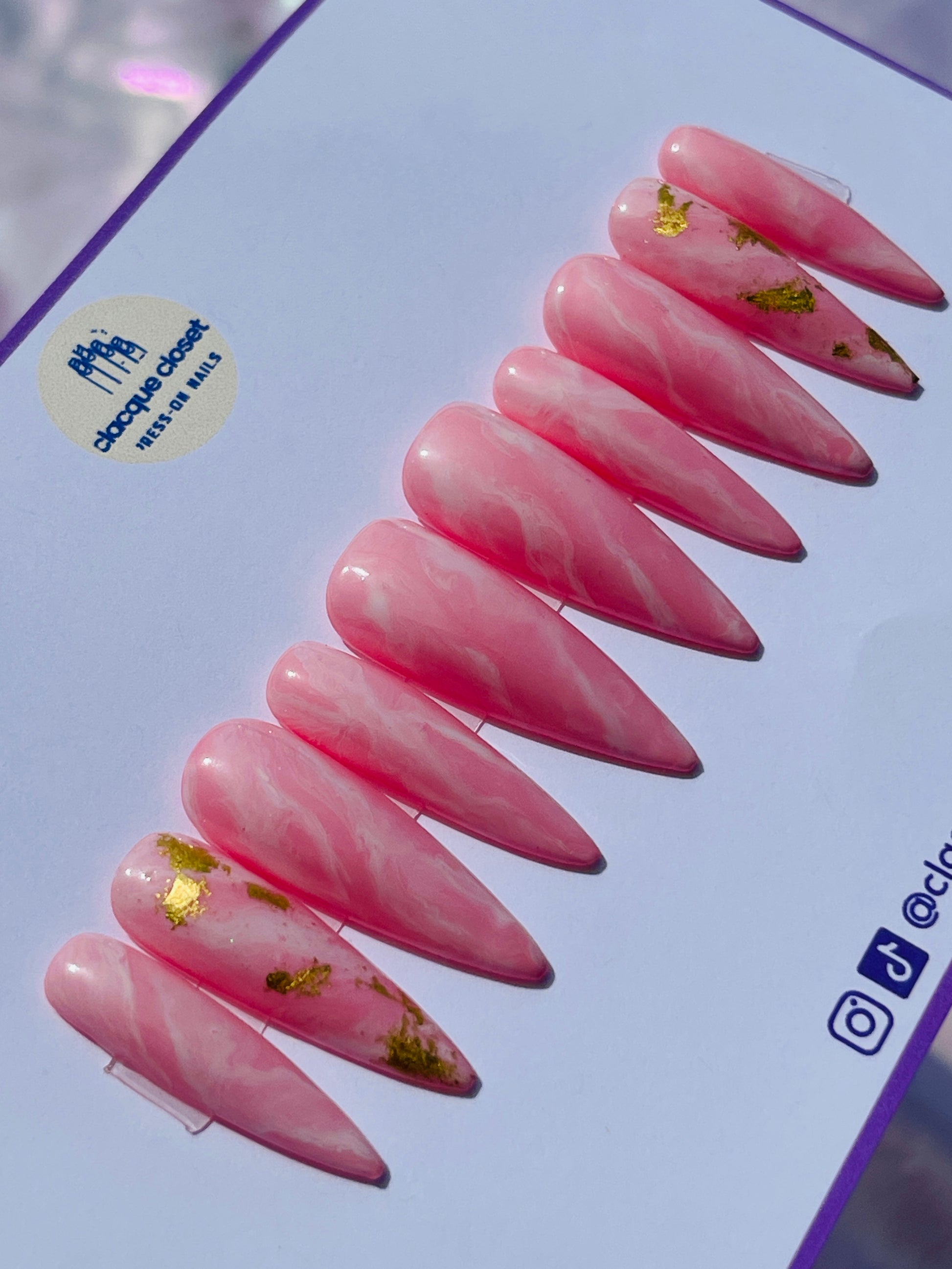 Long stiletto nails designed to resemble the natural beauty of pink rose quartz, reflecting light for a soft and romantic effect.