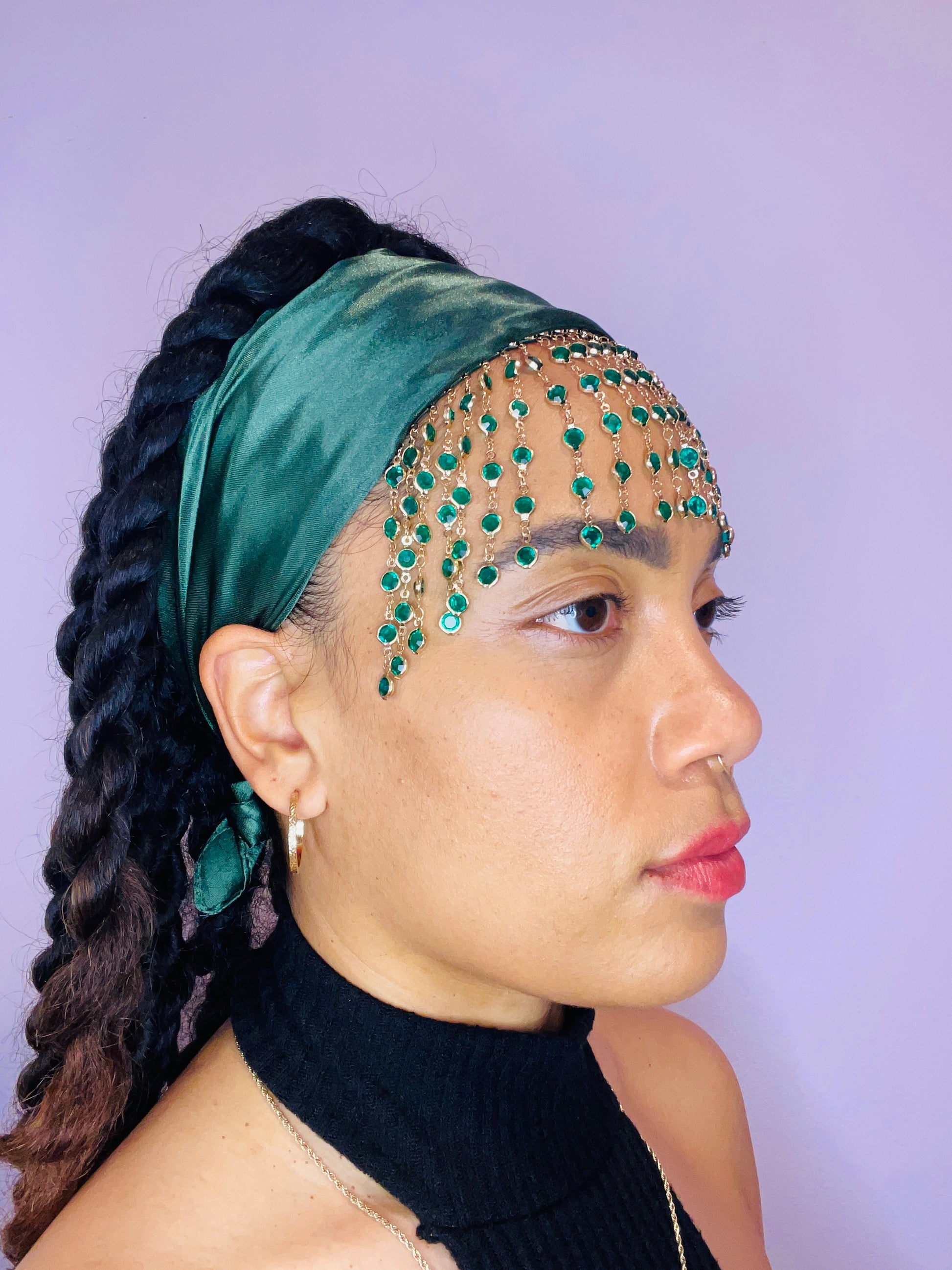 Model wearing the Demeter green bandana bang with green and gold beaded fringe tied in the back.