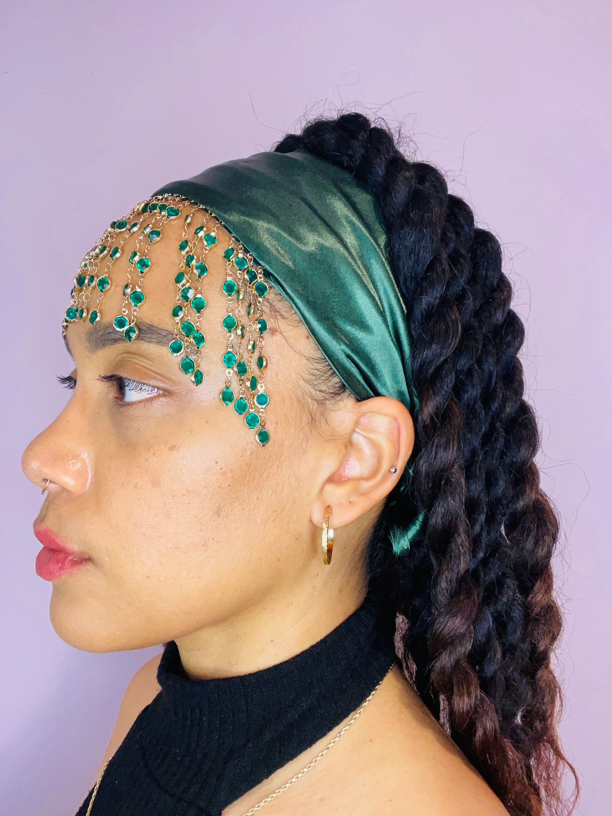 Model wearing the Demeter green bandana bang with green and gold beaded fringe tied in the back.