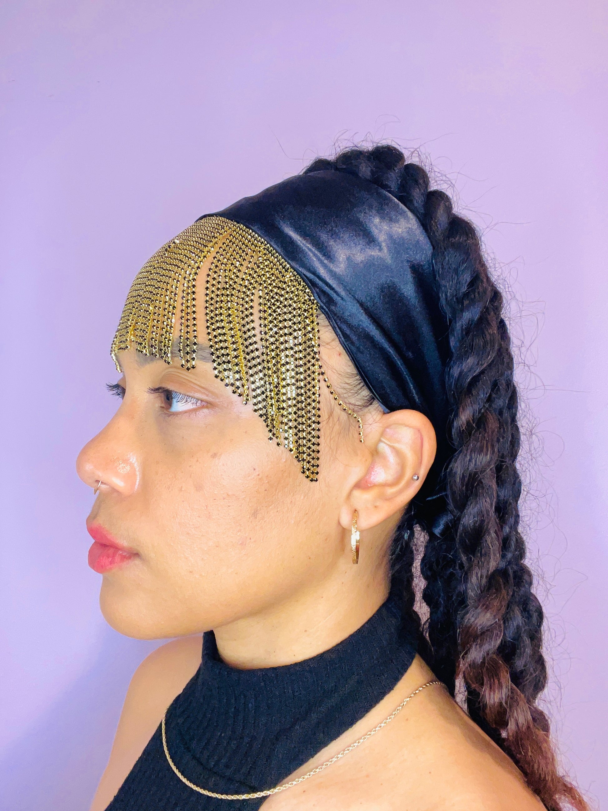 Model wearing the Minerva black and gold bandana bang with front fringe and tied in the back