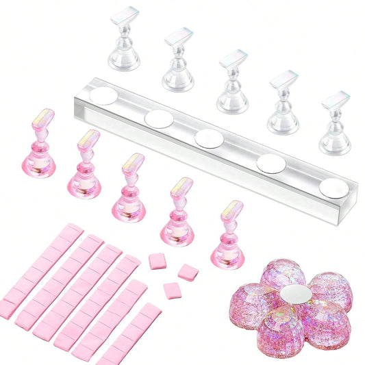 Set of pink resin molds and tools on a white background