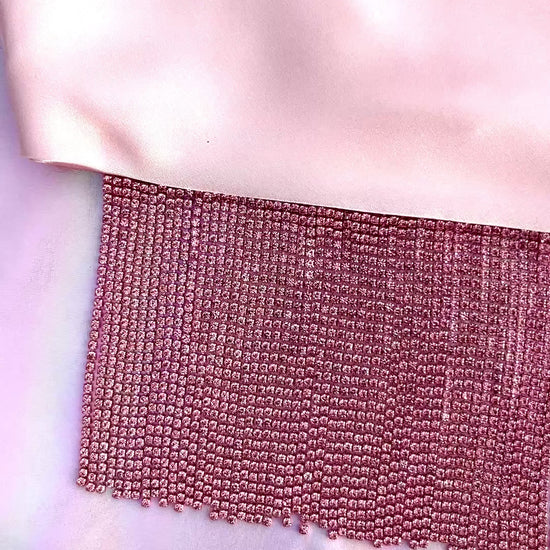Video of Xochi handmade pink satin bandana bang with pink rhinestone fringe laid flat